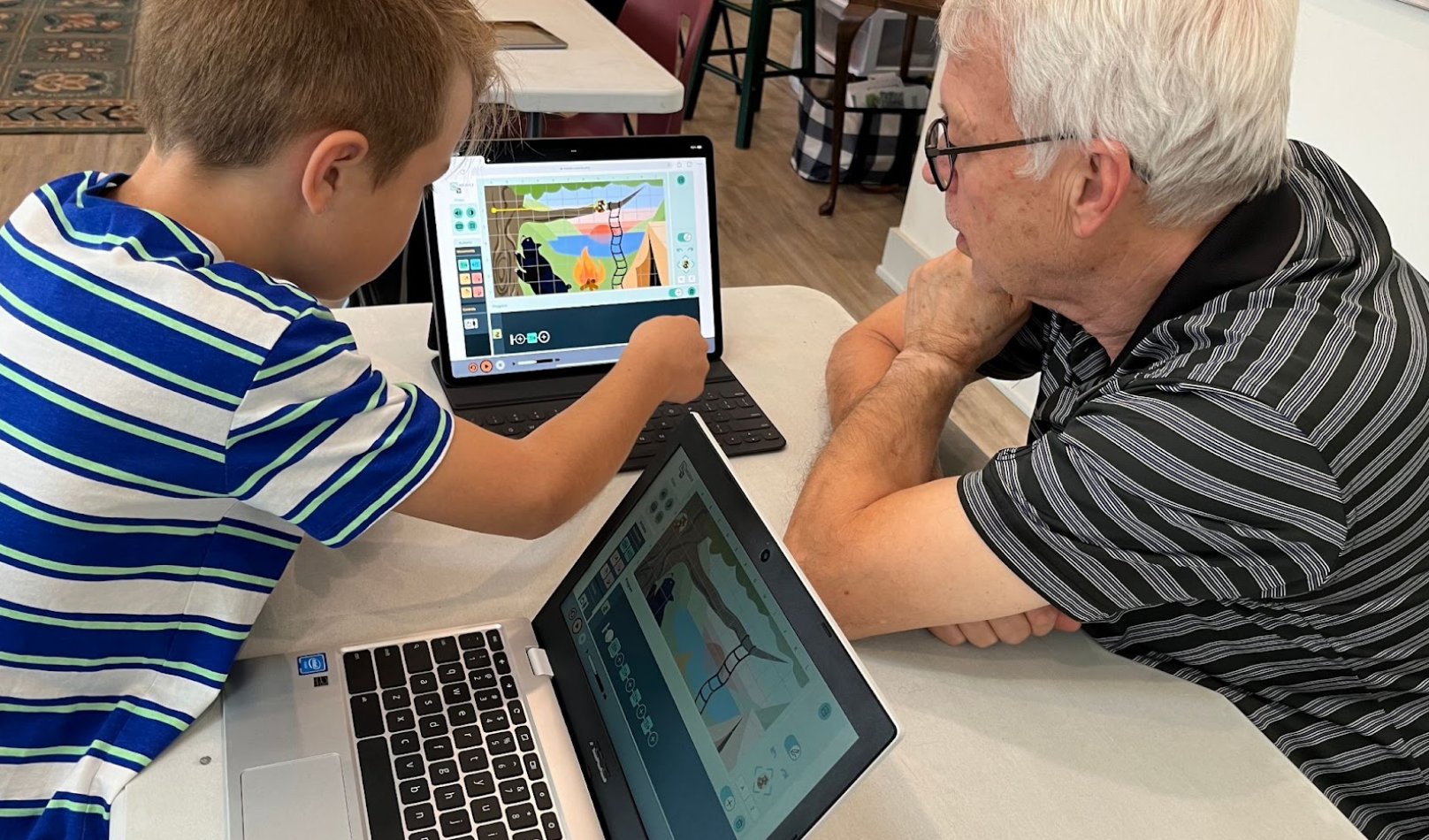 A senior and a child working together using Weavly.